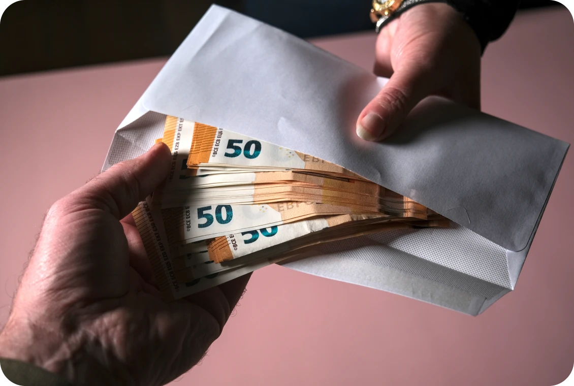 Person receiving cash-filled envelope